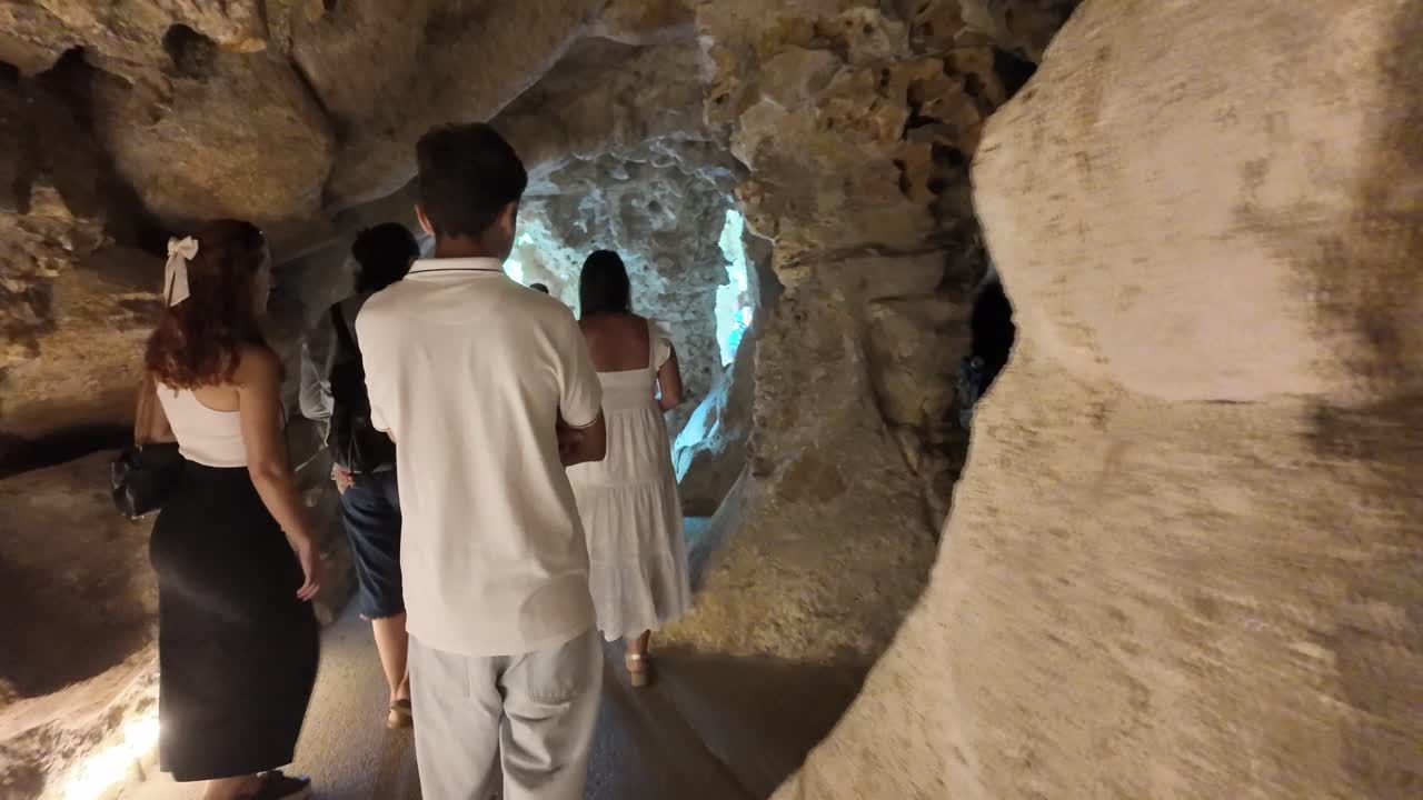 Tourists explore the rock formations inside Quinta da Regaleira's caves in Sintra, Portugal