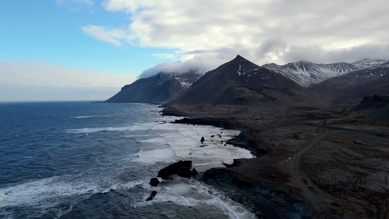 aerial view of Fauskasandur black scenic beach in Iceland seascape during a sunny day , cinematic drone footage