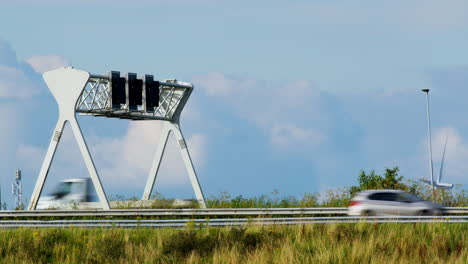 highway with traffic sign and wind turbines in the background