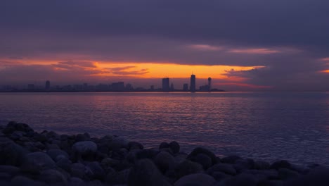 sea and sunset on the background of resort town. batumi in georgia.