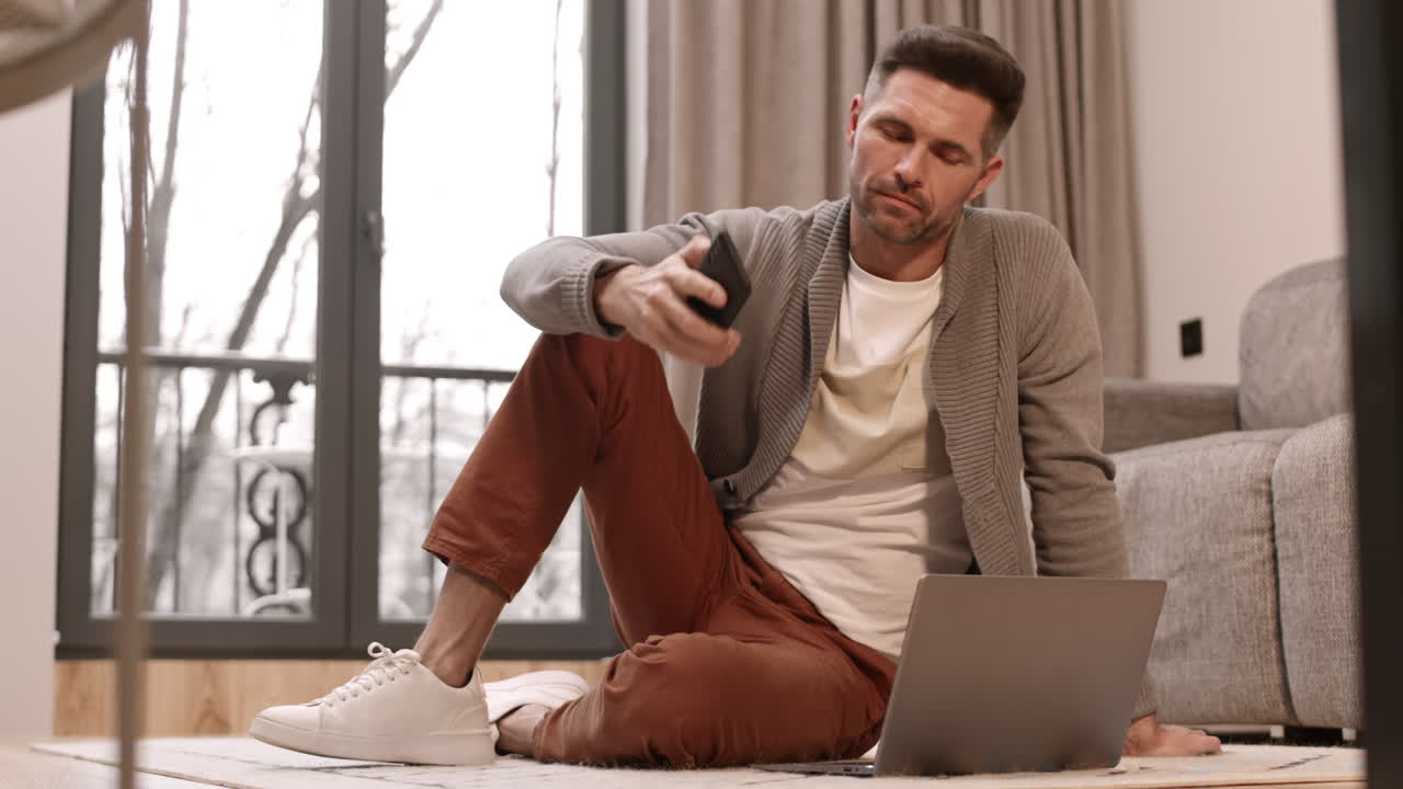 Man Using Smartphone and Computer