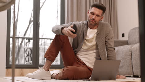 man using smartphone and computer