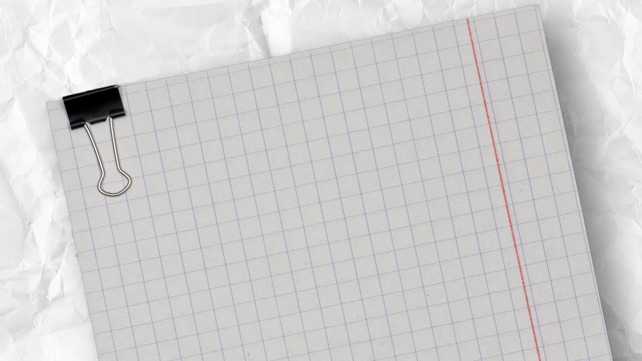 empty checkered paper with clip above a white crumpled and creased paper background. copy space for text, stop motion animation