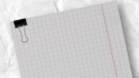 empty checkered paper with clip above a white crumpled and creased paper background. copy space for text, stop motion animation