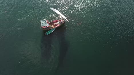 aerial drone orbit of sailing boat cruising on the sea