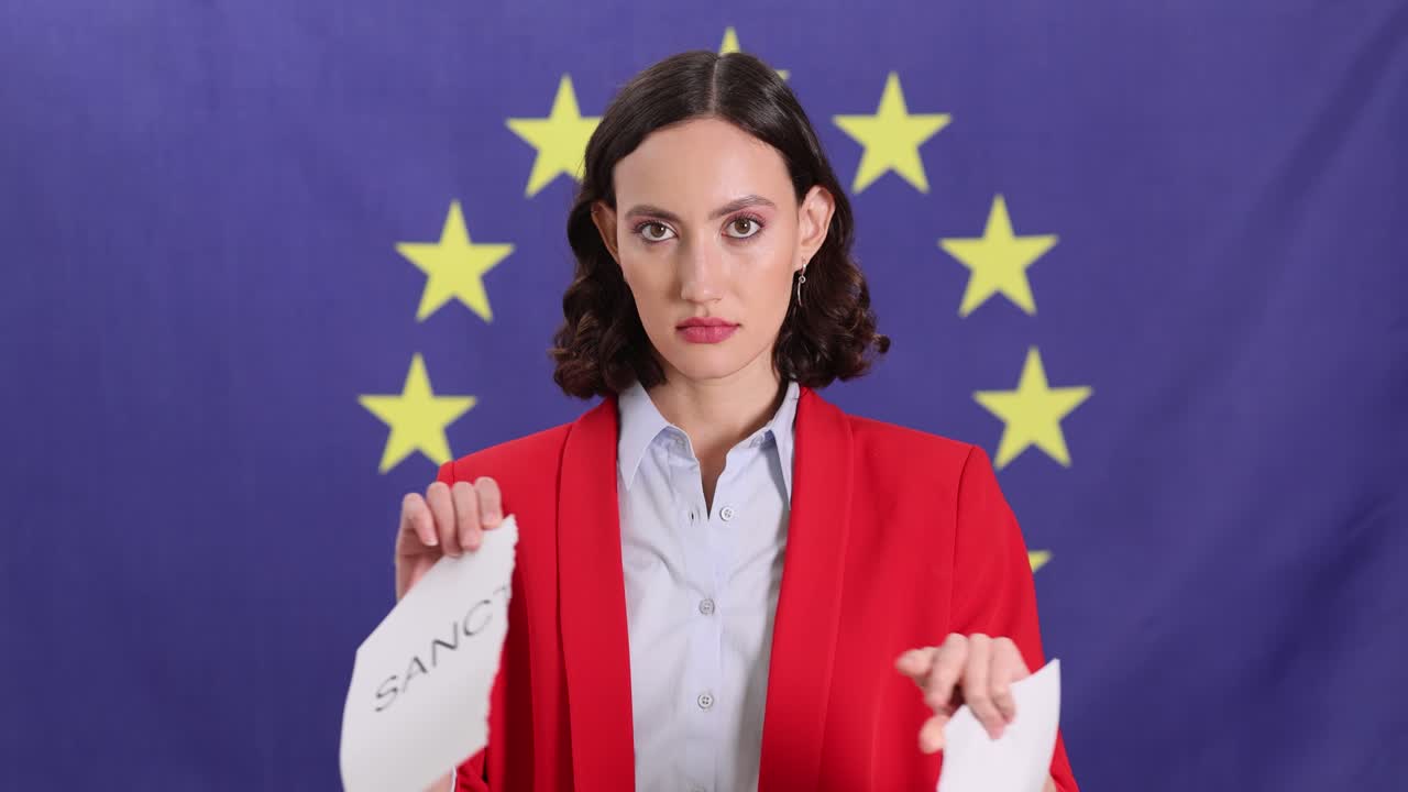 Woman tearing 'Sanctions' in front of EU flag