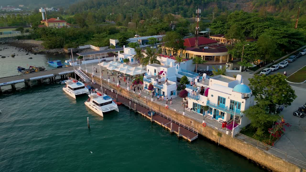 Aerial View of a Beautiful Coastal Town with Boats Docked at a Marina