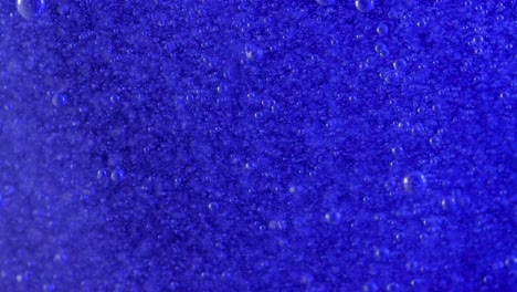 millions of tiny bubbles rise in a deep blue current, this is very relaxing to watch and could make an interesting background for green screen