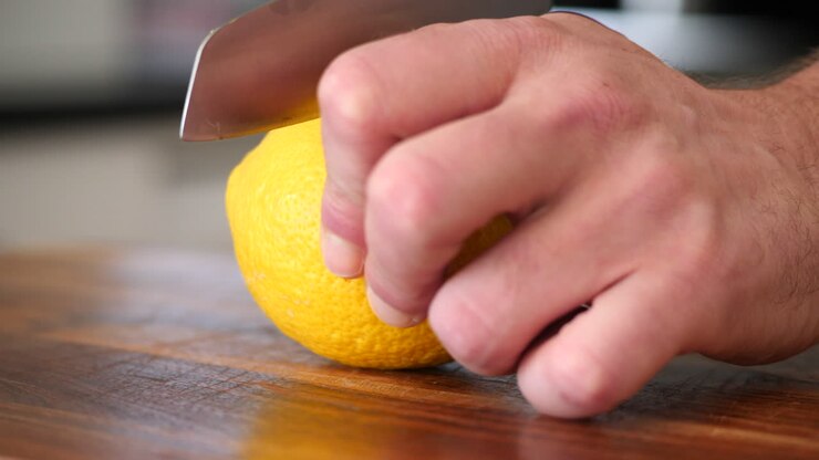 Cutting a lemon close up