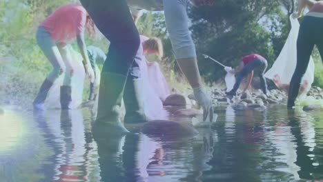 video of lights over diverse group picking up rubbish in countryside