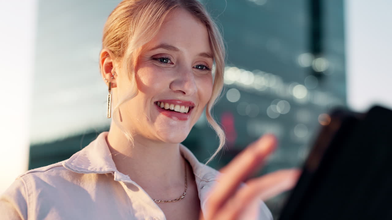 Portrait of a smiling blonde woman using a smartphone in the city