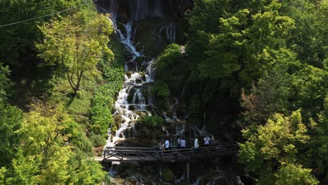 Aerial-shot-dollying-back-from-a-grand-tiered-waterfall-in-Sopotnica,-Serbia