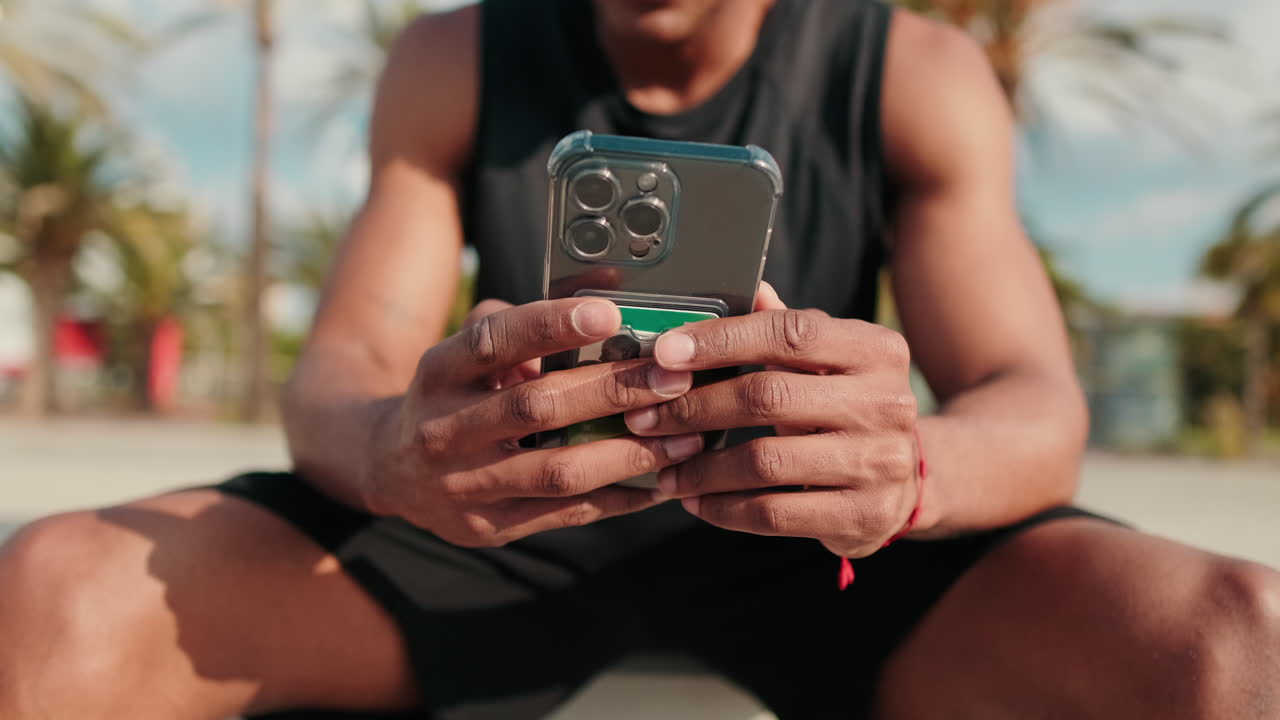 Athlete Checks Phone After Outdoor Workout