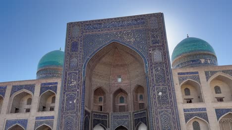 4k orbiting shot showcasing mir-i-arab madrasa in bukhara old town, uzbekistan