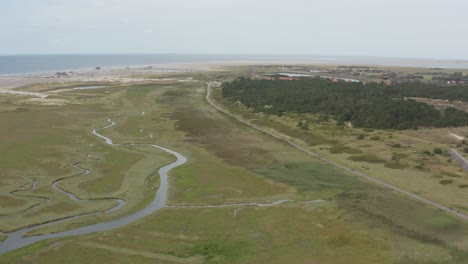 Cinematic-drone---aerial-shot-of-the-green-and-sandy-nature-beach-of-St