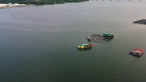 La-Vista-Aérea-Que-Muestra-Las-Granjas-De-Peces-Flotantes-Destaca-Las-Prácticas-Tradicionales-De-Acuicultura,-Incluida-La-Cría,-Crianza,-Cultivo-Y-Recolección-De-Peces-Y-Mariscos-En-Ambientes-Acuáticos.