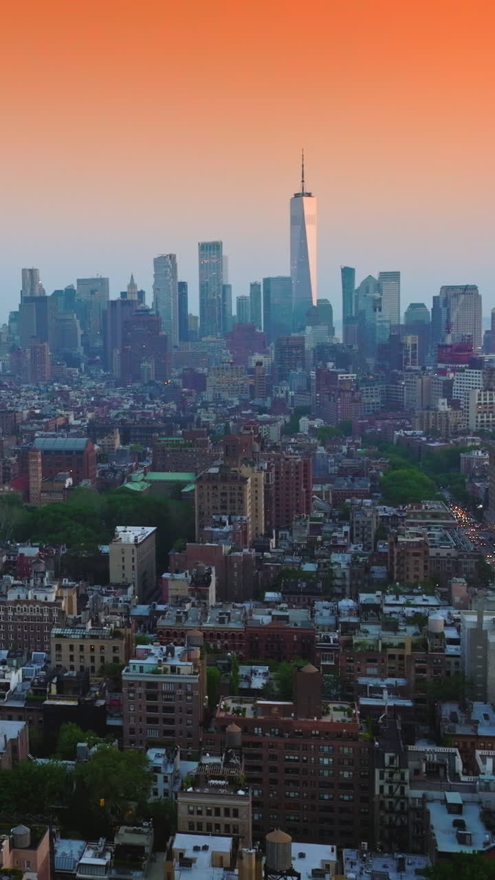 Diverse buildings of New York downtown at sunset. Beautiful skyscrapers towering at backdrop. Amazing pink sky background. Vertical video