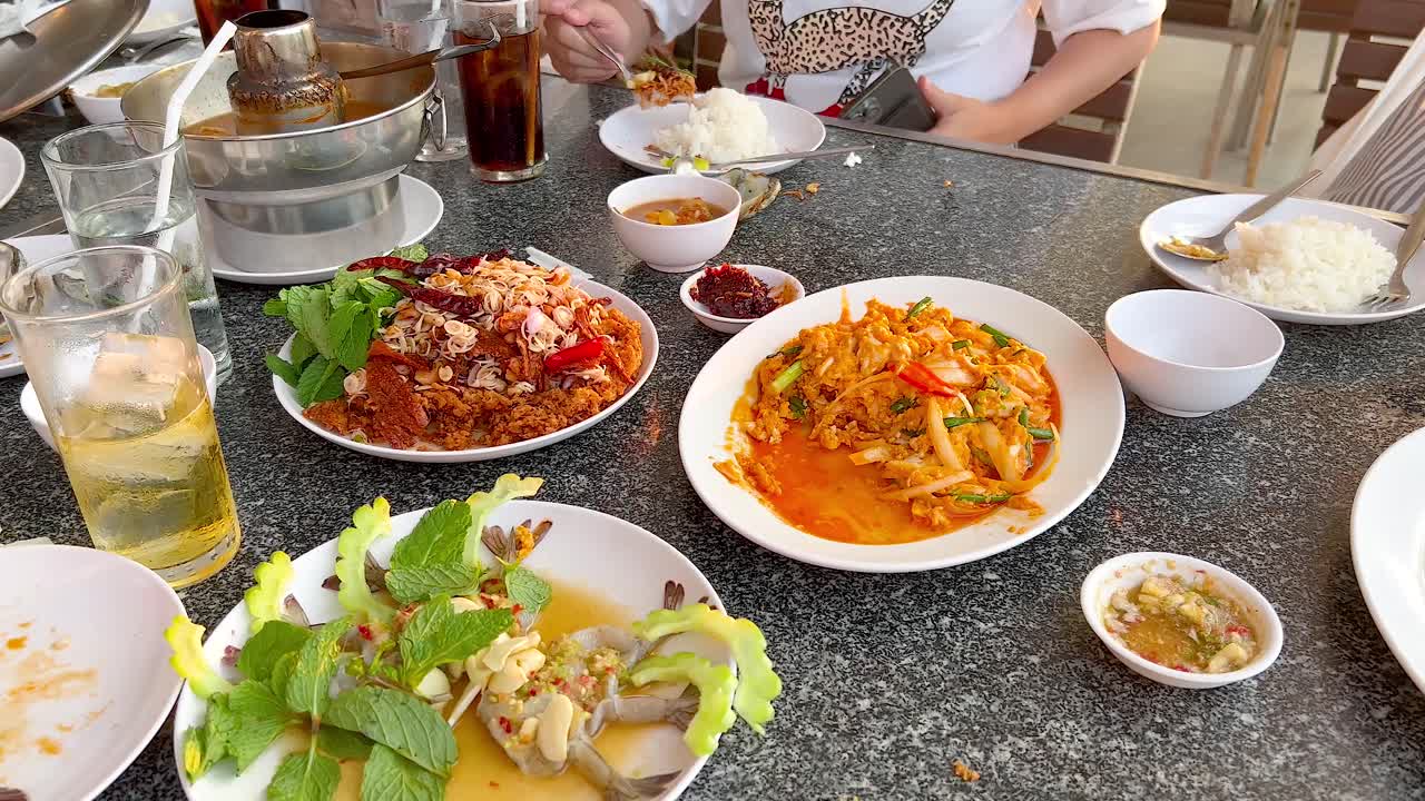 Group enjoying seafood meal in Chonburi, Thailand