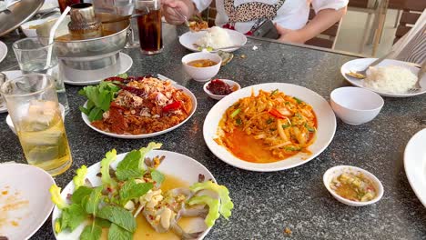 group enjoying seafood meal in chonburi, thailand