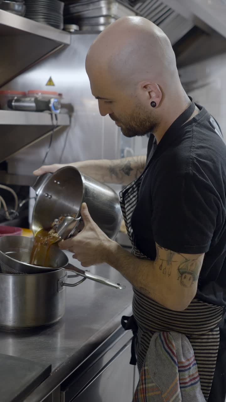 Chef straining liquid in a professional kitchen