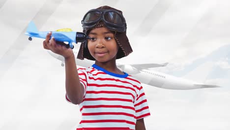 animation of happy african american boy playing with plane toy over silhouette of plane