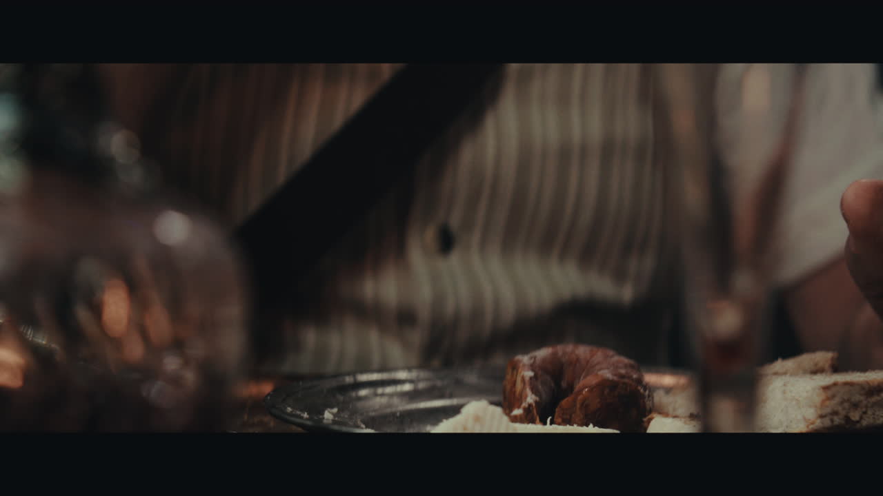 An old pirate eats and drinks inside the sailing ship cabin