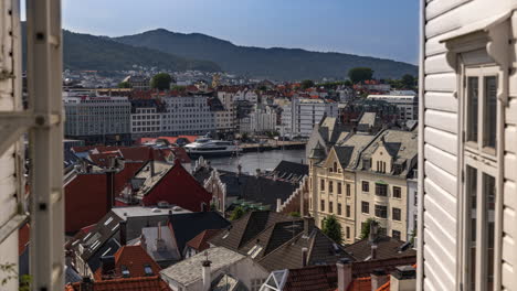 view of the old houses in downtown bergen and the harbor seen from between the houses in a small road called "smau"