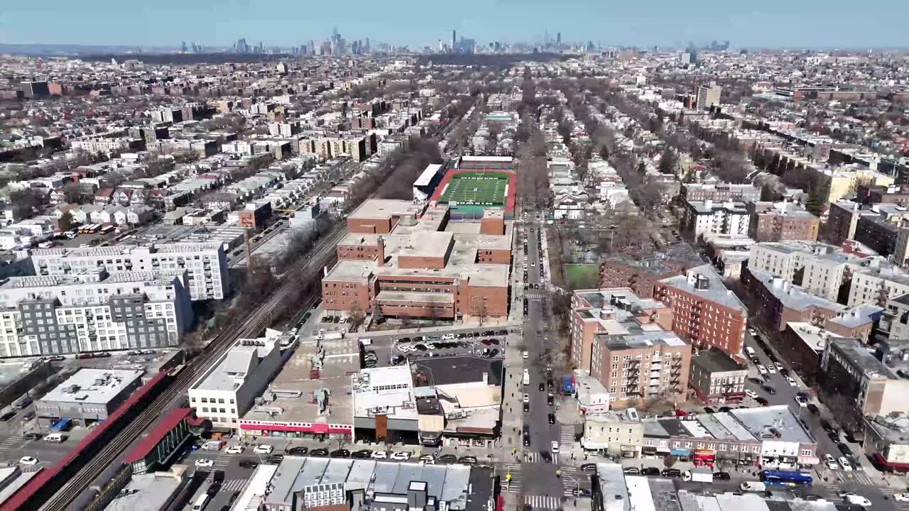 Horizontal drone side-tracking shot over Avenue M in Brooklyn, capturing the vibrant streets, residential buildings, and dynamic cityscape with smooth lateral aerial movement.