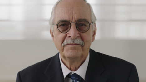 close-up-portrait-of-senior-businessman-executive-looking-serious-at-camera-middle-aged-professional-wearing-suit-smiling-happy