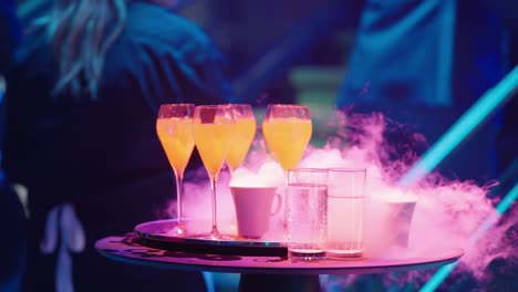 drinks with smoke and neon lights at a party