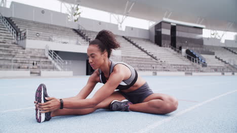 woman stretching on a track