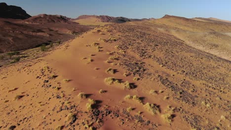 Flying-over-rocky-arid-Moroccan-desert,-aerial-drone-view