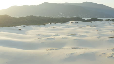 beautiful sunset sand dunes and rainforest mountains at praia da joaquina, florianopolis city, santa catarina, brazil