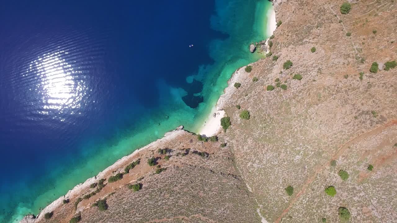Orbiting overhead drone shot of a secluded beach located in Kefalonia that belongs to the Ionian Islands in Greece