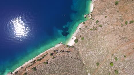 orbiting overhead drone shot of a secluded beach located in kefalonia that belongs to the ionian islands in greece