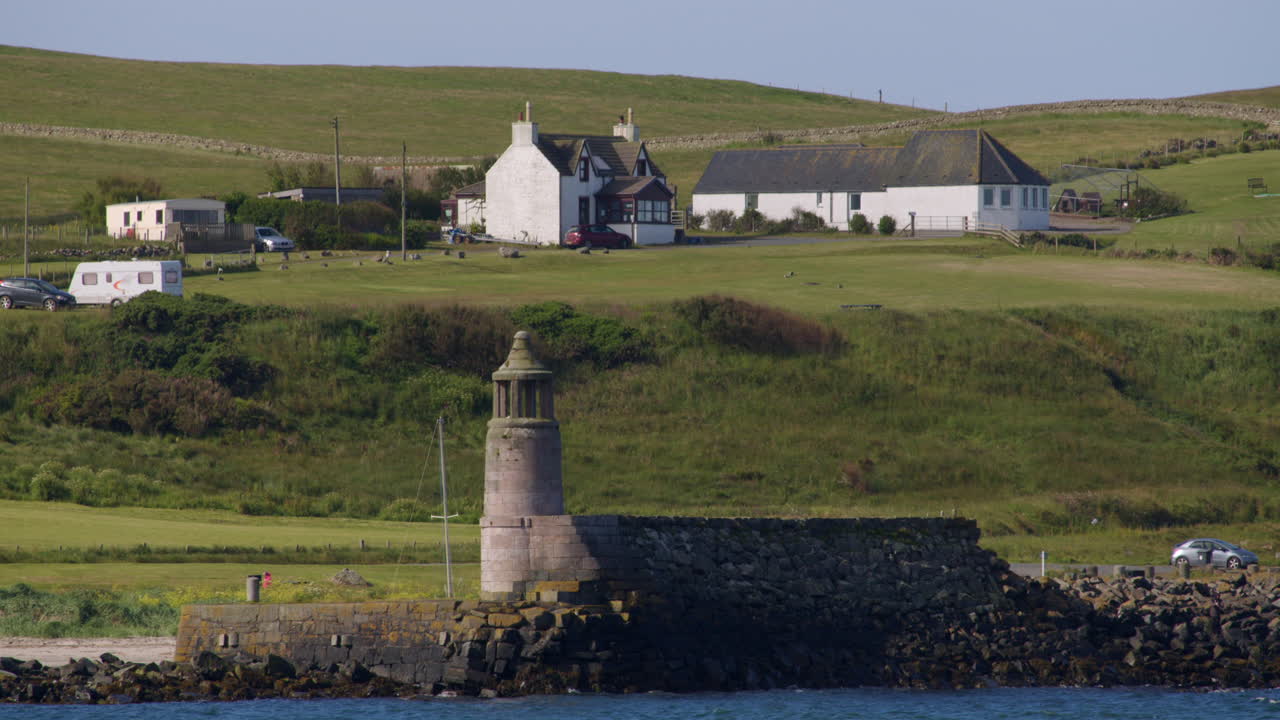 Picturesque Coastal Scene with Lighthouse and Houses