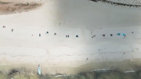 Wide-angle-aerial-drone-view-of-the-busy-sandy-white-beaches-of-the-tropical-island-of-Holbox-in-Mexico-during-a-really-hot-sunny-day-shot-in-4k