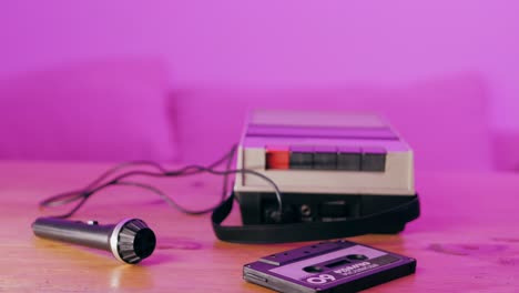 vintage cassette player and microphone on a wooden table