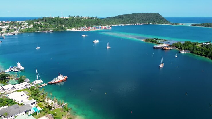 Aerial drone shot of Port Vila wharf bay dock with sail boats yachts ship Ifira Island travel tourism holiday destination Pacific Islands Vanuatu 4K