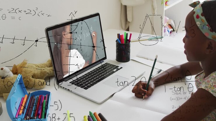 Learning math online, child using laptop with animation of equations in school