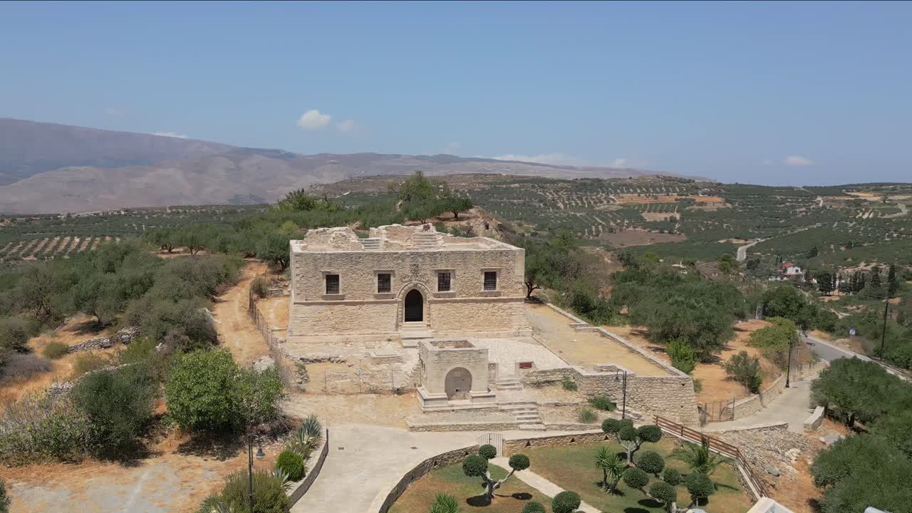 Orbit aerial view of the Venetian Mansion De Mezzo in Agios Nikolaos, Crete, showcasing its historic architecture and charm
