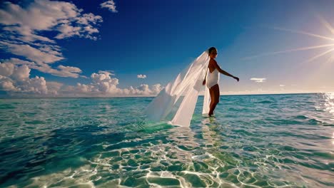 bride walking in the shallow water at sunset