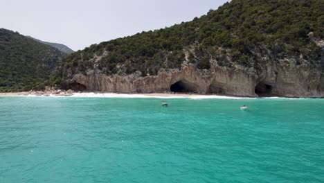 scenic coastal landscape with turquoise water, cliffs, and caves