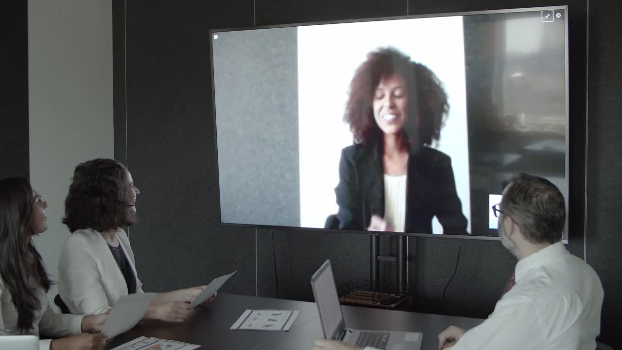 African American manager talking with partners via video call