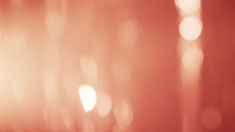 video of flickering white bokeh spots of light with copy space on red background