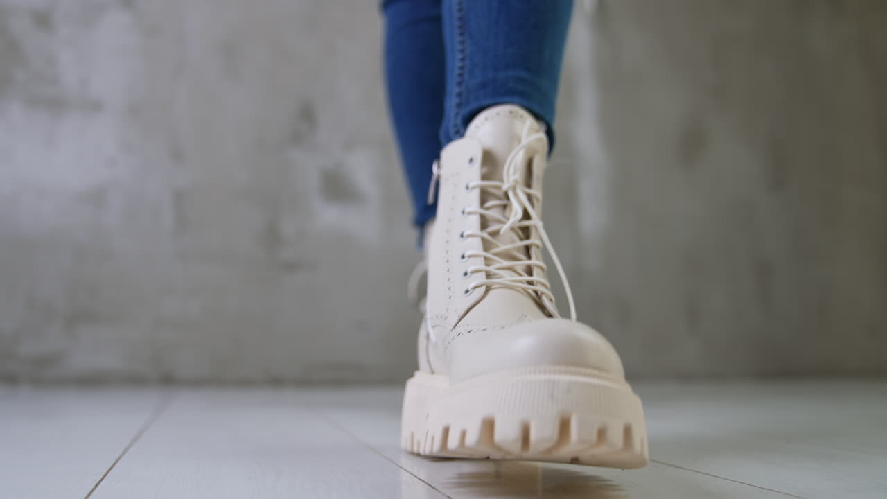 Woman Wearing White Platform Boots and Jeans