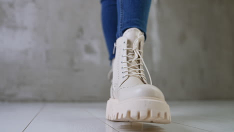 woman wearing white platform boots and jeans