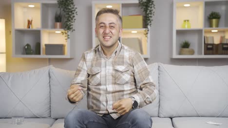 man giving greeting and applause to camera.