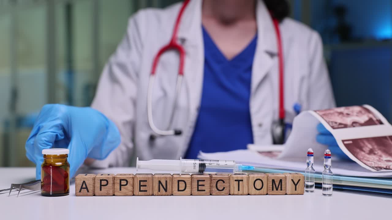 Doctor places tweezers on table and studies ultrasound images