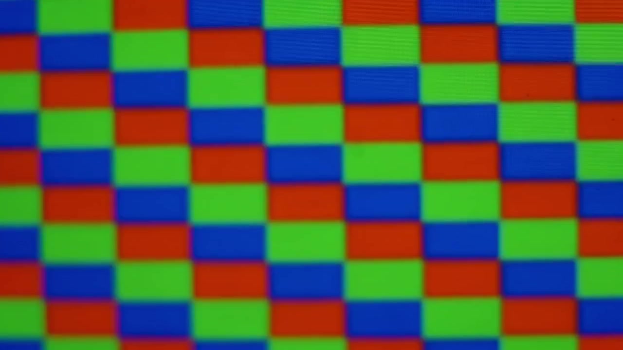 Close up of RGB rectangular pixels moving in a strobing pattern while slowly shifting in and out of focus